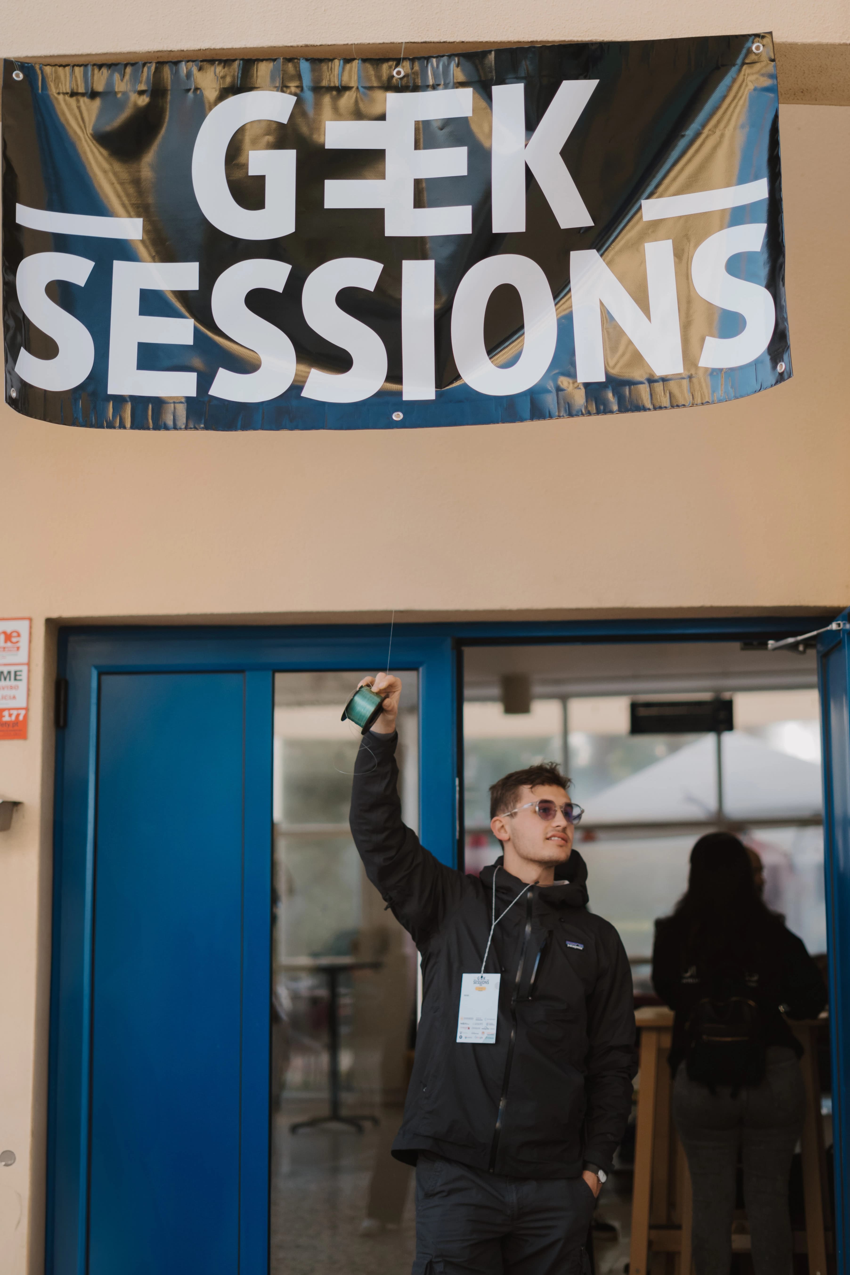A speaker giving a technical presentation at GeekSessionsConf 2025