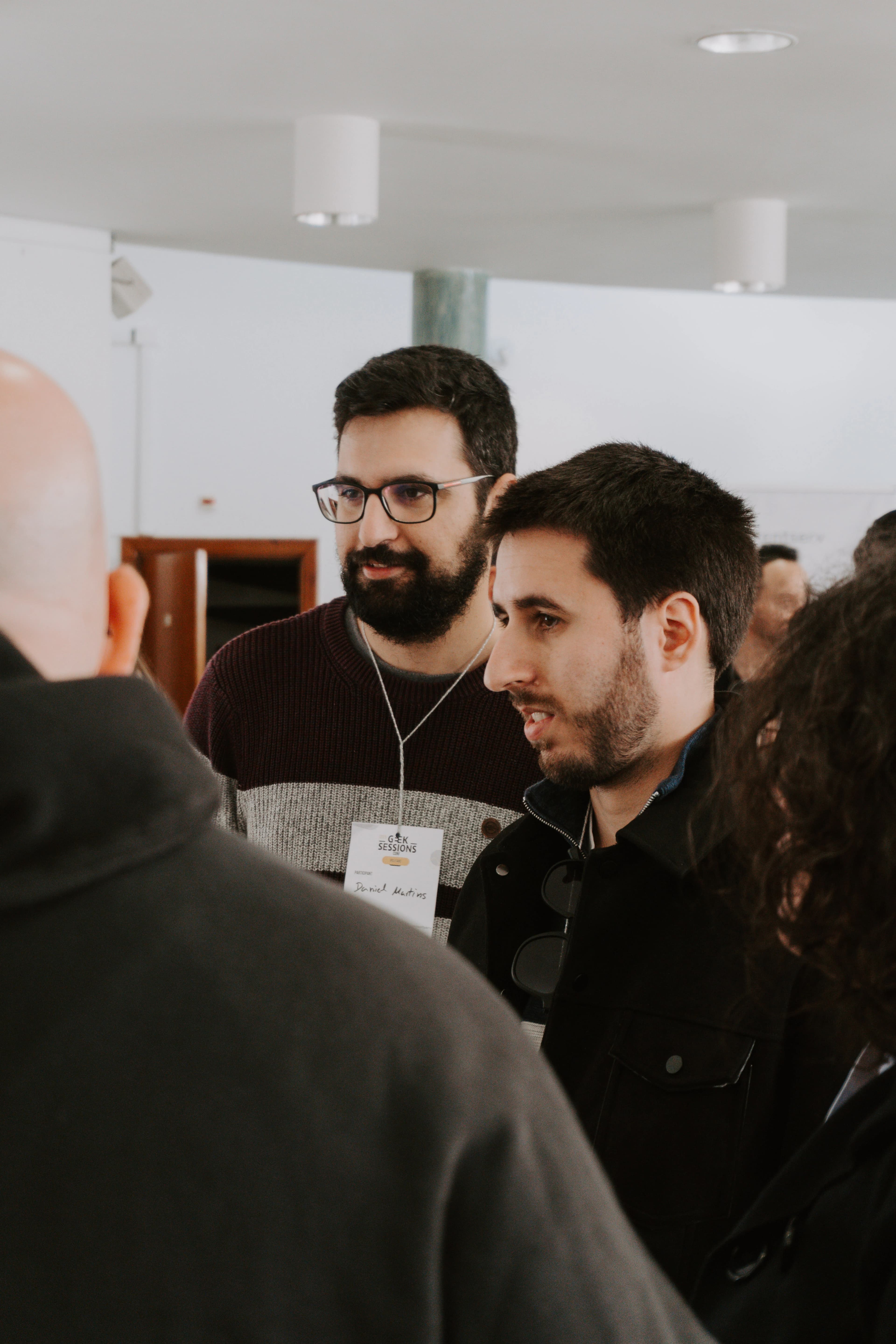 Panel discussion on stage with multiple speakers at GeekSessionsConf 2025